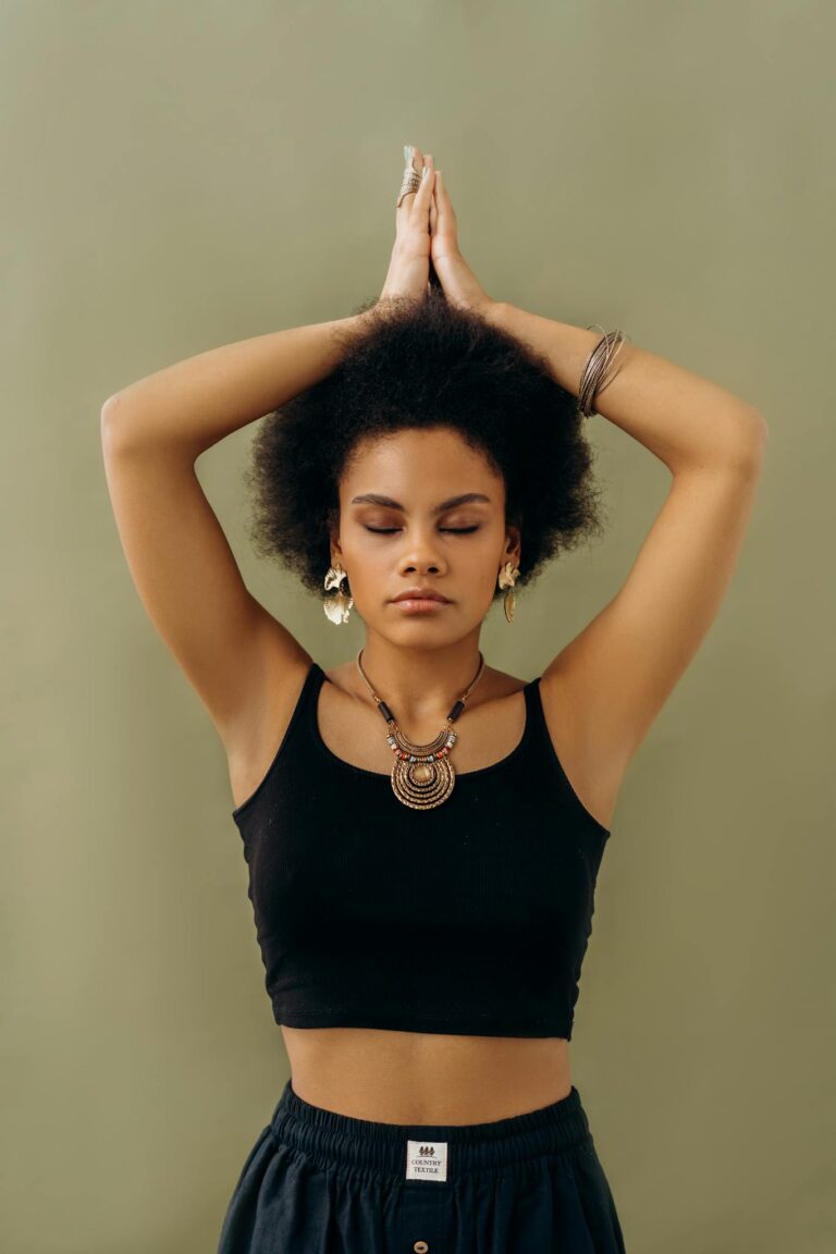 A woman in a yoga pose with closed eyes, symbolizing tranquility and self-awareness.